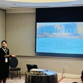 Jingyan Wang presenting at a conference in Atlanta