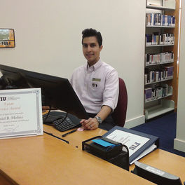 Daniel Molina, Communication & Information (Masters Student, Information), Working the FIU Law library circulation desk