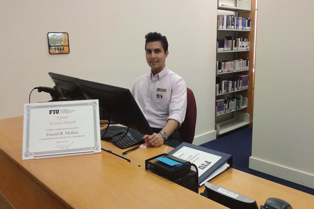 Daniel Molina, Communication & Information (Masters Student, Information), Working the FIU Law library circulation desk